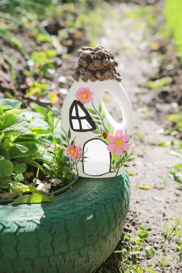 Fairy house sitting on a green tire